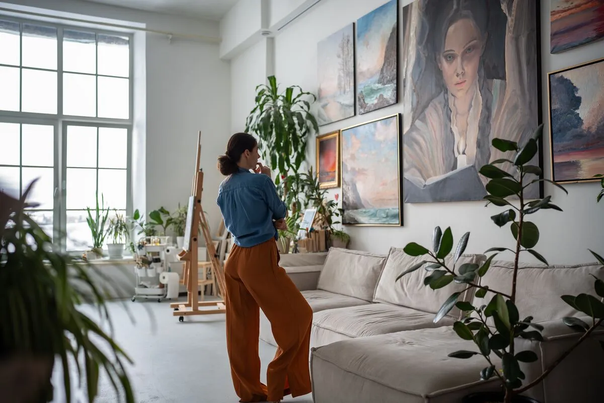 Painter,Woman,Looking,At,Painting,In,Artist,Creative,Cozy,Studio.