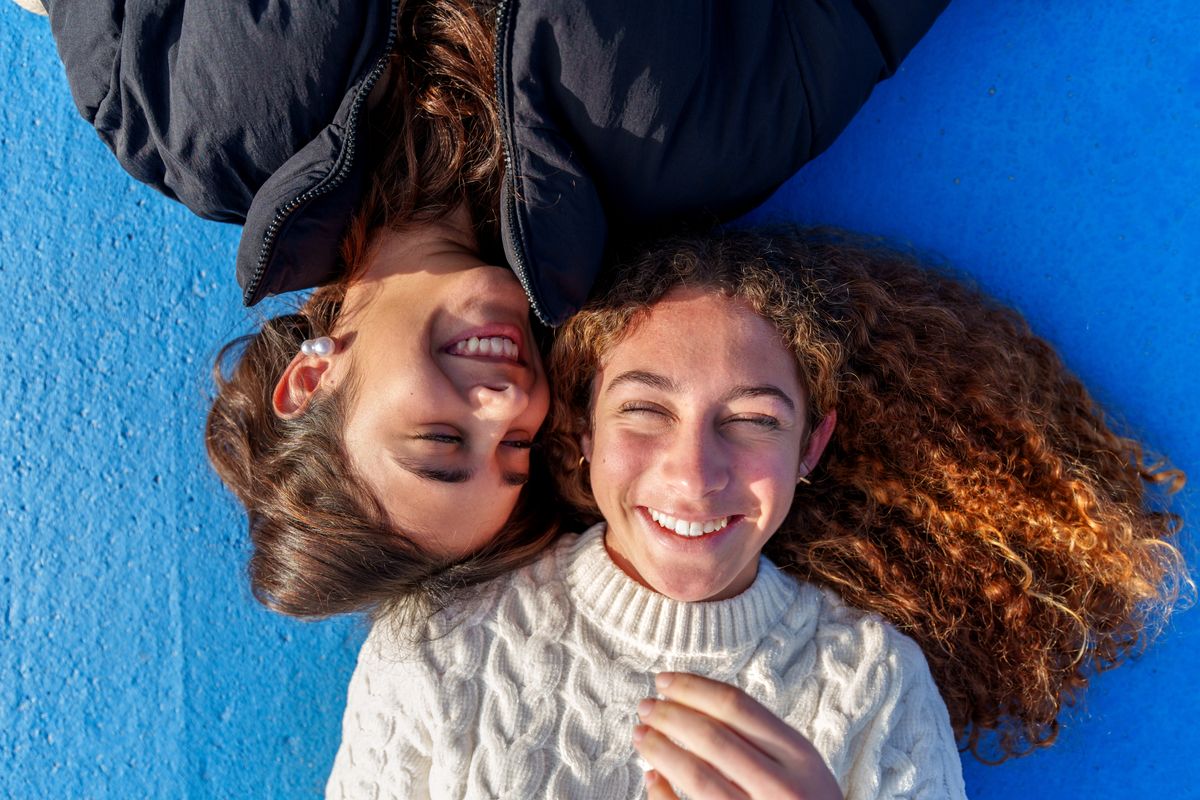 Teenage,Friends,Bonding,,Lying,Side,By,Side,,Heads,Touching,,Sharing