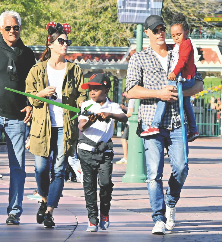 EXCLUSIVE: Sandra Bullock and her boyfriend Bryan Randall are joined by Jason Bateman and his family while spending the day at Disneyland