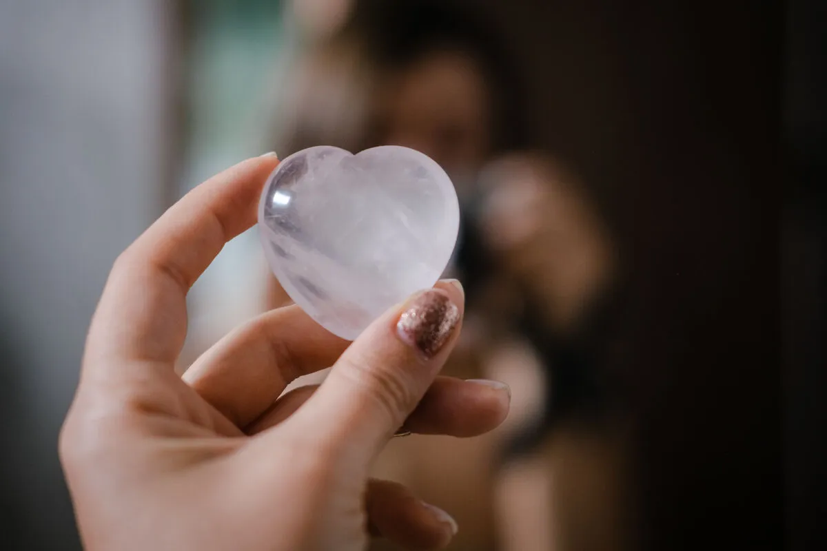 Woman,Holding,In,Hand,Rose,Quartz,Heart,Shaped,Crystal