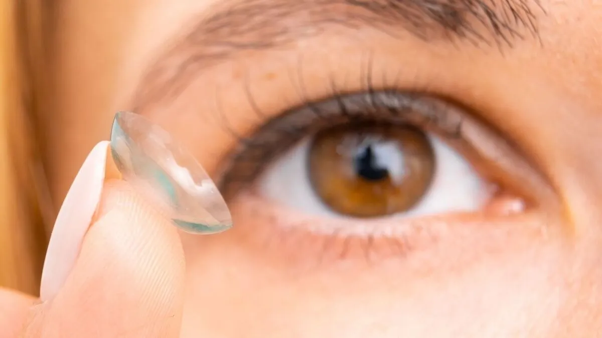 Contact lens for improvement of vision, closeup to female brown eye