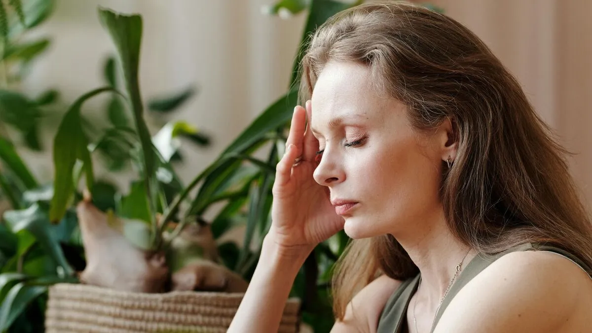 alt=A fiatal lány elviselhetetlen fejfájással szenvedett egyik hétköznapi tevékenysége közben 