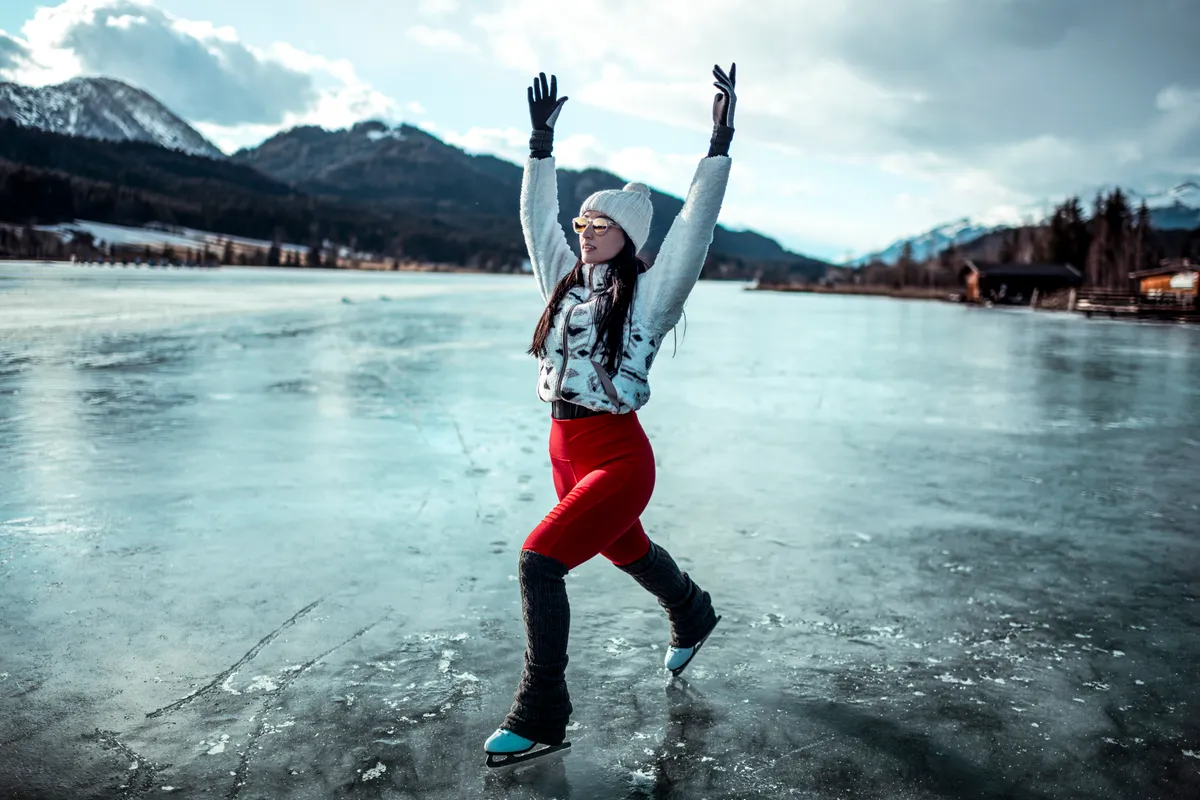 An amateur female skater making twirls and figures while skating on the frozen lake