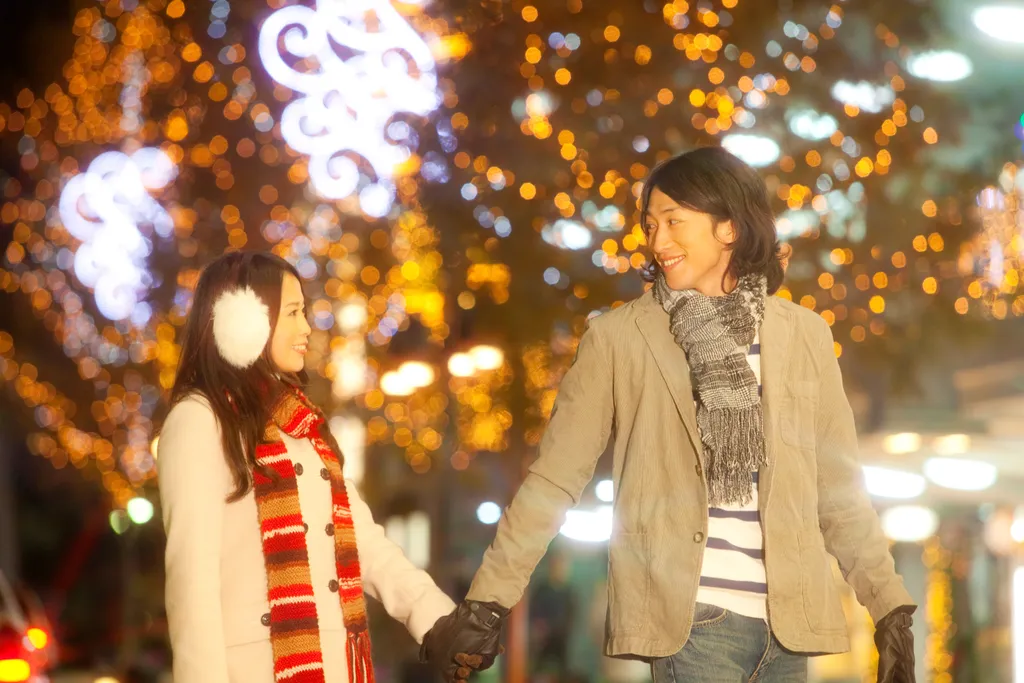 Couples walk the streets that was decorated for Christmas illuminations