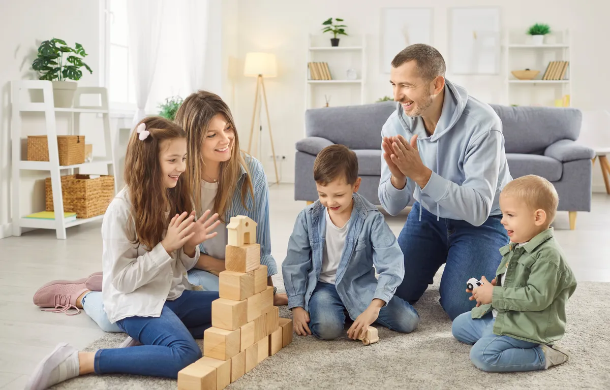 Happy,Parents,Playing,Educational,Game,With,Their,Three,Children,,Building