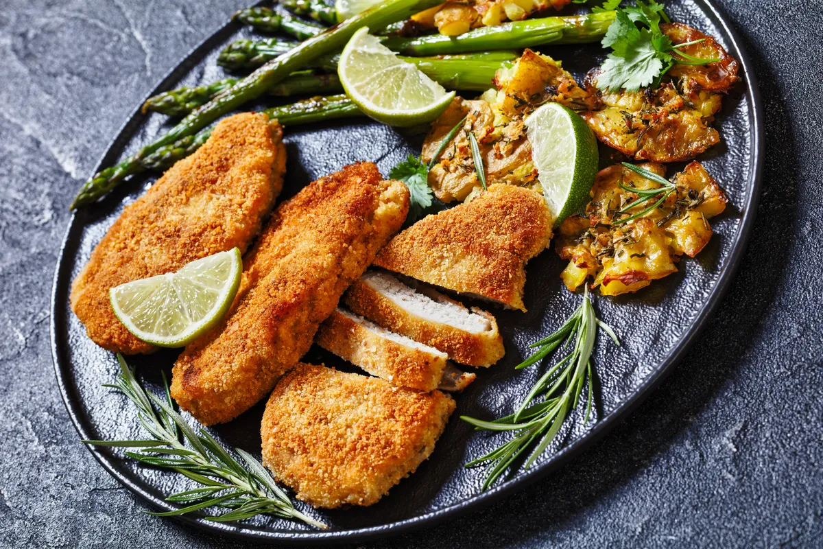 Trükk: rántott csikemell készítéshez Fried,Breaded,Chicken,Breasts,With,Roast,Asparagus,,Smashed,Potatoes,And