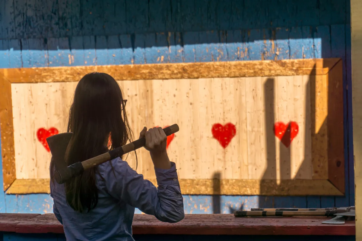 Woman,Throwing,An,Axe,At,Target,For,Fun