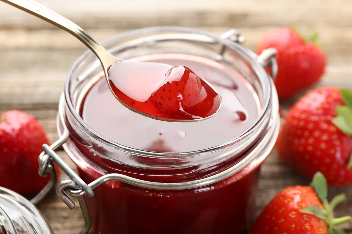 olcsó Taking,Tasty,Strawberry,Jam,With,Spoon,At,Wooden,Table,,Closeup