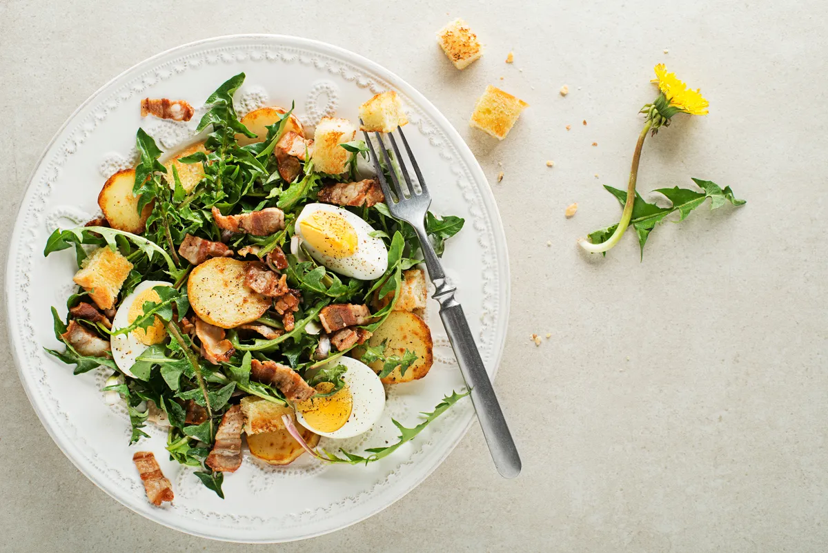 Dandelion,Salad,With,Egg,Bacon,Potato,And,Croutons,On,Grey