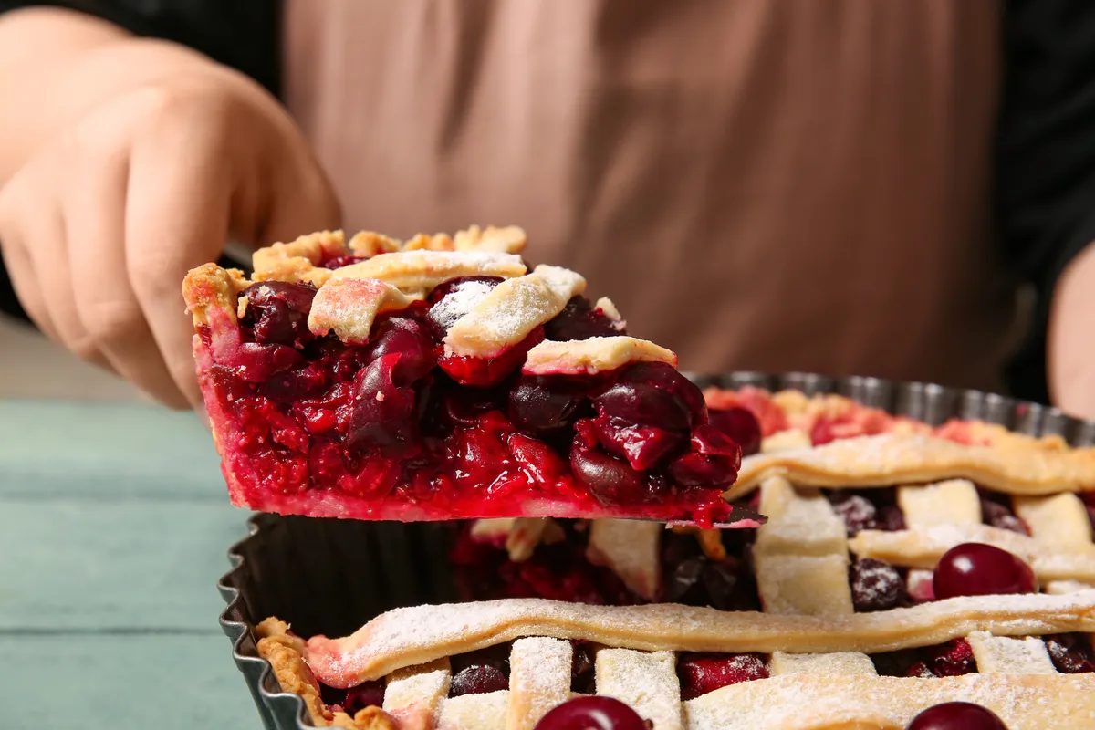 Meggyes pite Woman,Taking,Piece,Of,Tasty,Cherry,Pie,,Closeup
